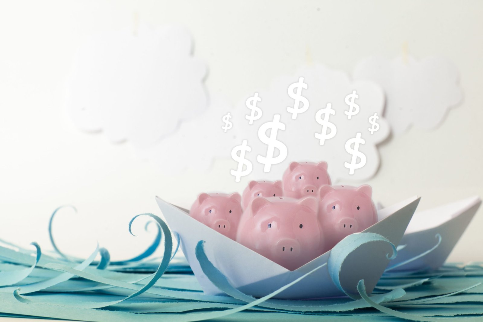 Image of piggy bank in a paper boat to accompany post about money saving tips for boat and rv storage.