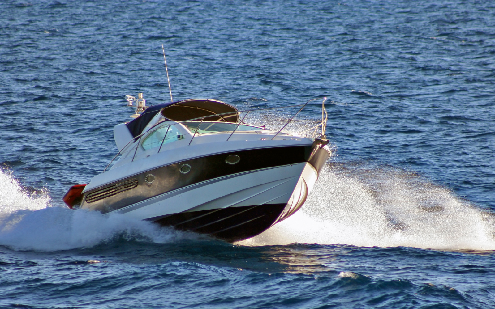 Picture of ski boat on water with high wake